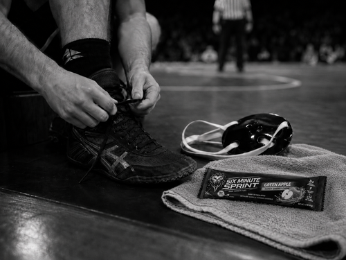 Athlete tying shoes with Green Apple Chew nearby